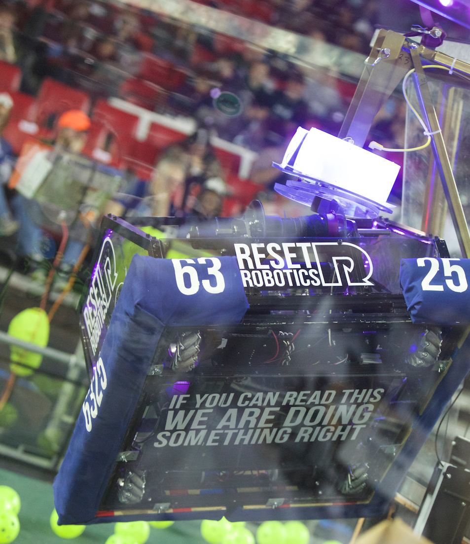 An FRC robot with blue bumpers showing its team number, on the field during a match